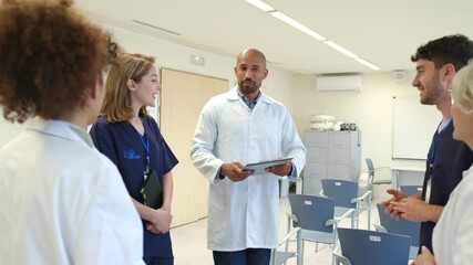 Medical team discussing patient cases in hospital meeting room