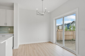 Large open kitchen with a white wall and a wooden floor