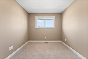 Small room with a window and a white wall