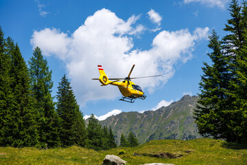 Flying rescue helicopter of emergency medical service in mountains. Air vehicle ambulance alpine...