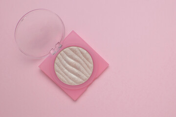 Pink Compact with Shimmery Powder on Minimalist Background: Beauty and Makeup Trends 2023