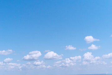 Scattered cumulus clouds on clear blue sky, creating a clean and airy texture. Ideal for use in...