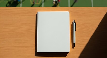 notebook and pen on wooden table