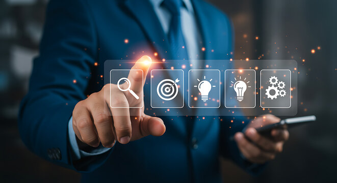 A businessman in a suit uses a digital interface to select business strategy icons, representing goals, ideas, and solutions
