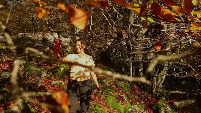 Woman capturing autumn in Gorbea Natural Park