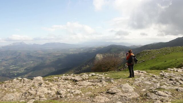 Woman is capturing the breathtaking view of Gorbea Natural Park