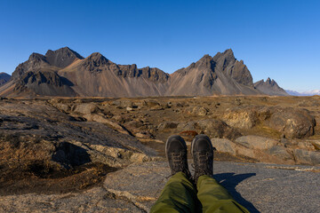 Hiker enjoying the view of Vestrahorn mountain in Iceland on a beautiful sunny spring day