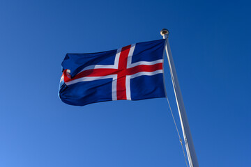 Icelandic flag waving in the wind on a blue sky