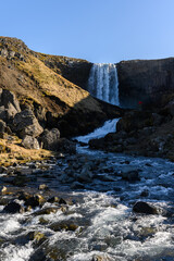 Photographer taking pictures of Svodufoss waterfall in Iceland