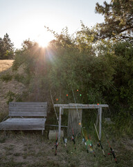 Wooden bench and a collection of fishing poles
