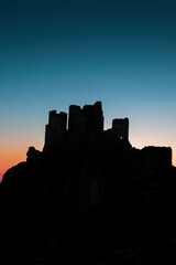 Obraz premium Italy, July 5, 2025: Ruins of Rocca Calascio Castle, an Italian tourist destination and landmark in the Gran Sasso National Park, L'Aquila, Abruzzo. Clear blue skies at .