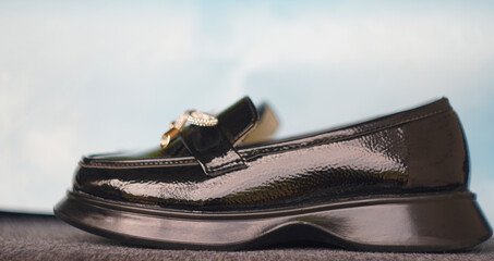 Girls' shiny black shoes on the carpet