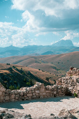 Italy, July 5, 2025: Spectacular view of rolling hills with the mountains of Abruzzo on the horizon at sunset. The clear sky provides the backdrop.