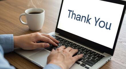 Hands typing on laptop with thank you message and coffee cup.
