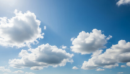 Obraz premium Soft cumulus clouds scatter across the open sky, contrasting gently with the rich blue backdrop to evoke feelings of freedom and endless space.