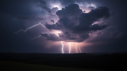 Obraz premium A dramatic lightning storm illuminates a dark landscape, capturing the raw power of nature with glowing cloud details.