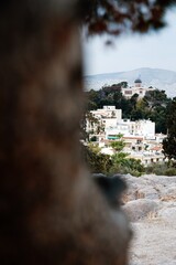 A scenic view of the Athens National Observatory captured from the rocky slopes of Areopagus Hill. 