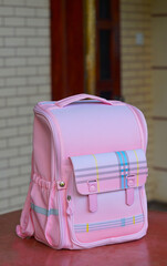 Pink children's backpack on the tabl