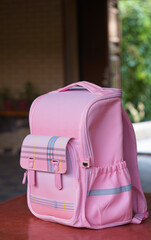 Pink children's backpack on the table