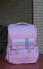 Pink children's backpack on the table