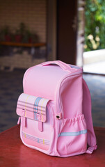 Pink children's backpack on the table