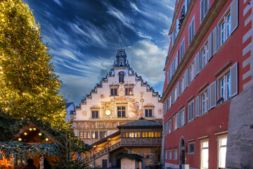 Historic town hall in Lindau on Lake Constance. A festively illuminated Christmas tree provides warmth and festive charm.