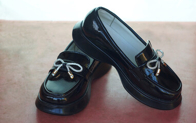 shiny black girls' shoes stand