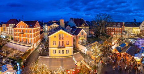 Panoramic shot of Lindau Christmas market at Lake Constance with festively lit buildings