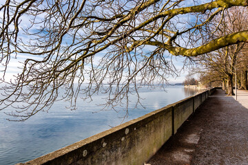 Wintry lakeside promenade in Lindau overlooking the calm Lake Constance