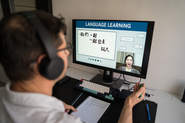 Man learning Mandarin online at home
