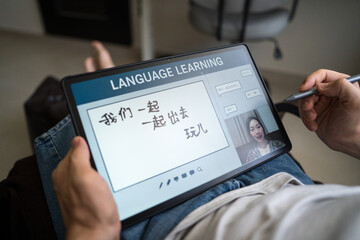 Man learning mandarin online from home setting