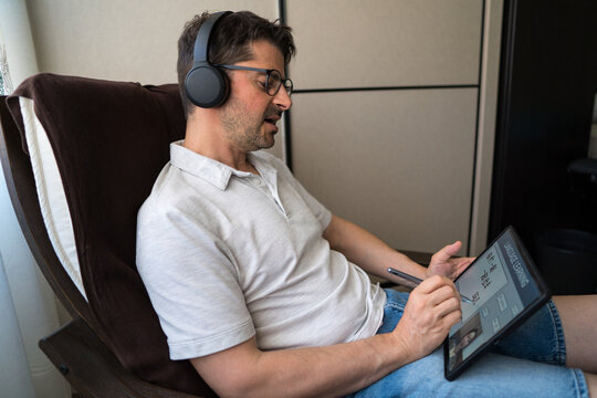 Man studying mandarin at home with tablet