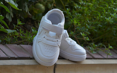 White sneakers on the ground in nature