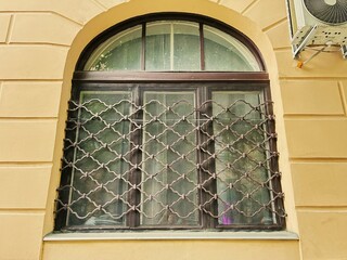 A meticulously renovated building facade, with an outdoor air conditioner above its well-maintained...
