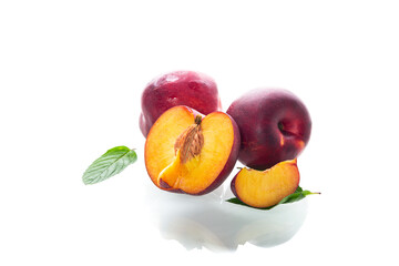 Whole and cut nectarines on clean background