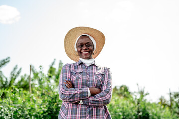 Smiling Farmer in a Straw Hat in Green Agricultural Field