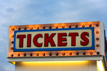 Illuminated ticket booth sign at the fair at twilight in New England