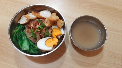 Chicken Noodles Soup With Shitake Mushroom Served With Various Dishes on Stainless Bowl at Wooden Table