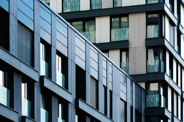 High-density residential building with white and black grid and vertical balconies