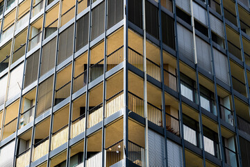 Fototapeta premium Residential tower with deep balconies and a grid of glass and concrete