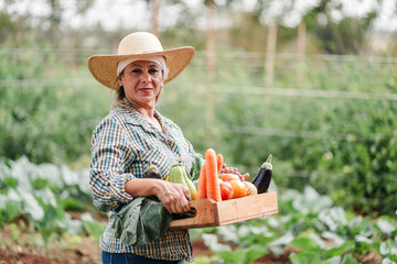 Female Farmer Holding Fresh Vegetables in a Lush Garden