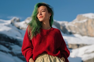 Asian young female with green hair in snowy mountain landscape