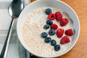 oatmeal top with blue berries and red raspberries