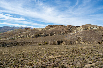 Arid Landscape with Rocky Hills Under Blue Sky