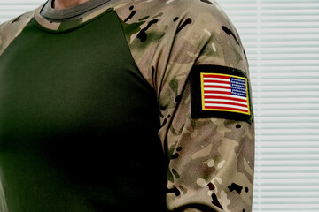 Fototapeta premium Camouflage uniform with American flag. Modern US military uniform.