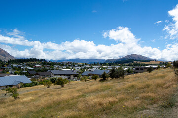 Scenic Town View with Mountains and Blue Sky