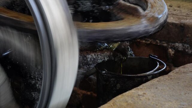 An industrial process involving machinery and liquid, possibly oil or lubricant
