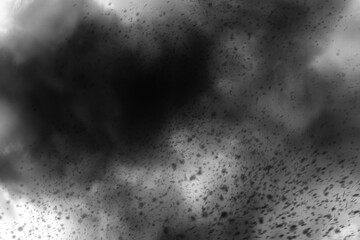 Abstract monochrome image showing a dense swarm of particles suspended in a hazy environment view