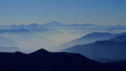 Layered Mountain Range in Atmospheric Mist at Dawn