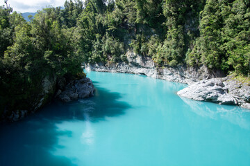 Turquoise River Surrounded by Lush Greenery